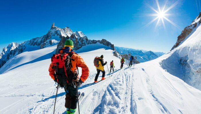 group of skiers in french alps on a sunny day