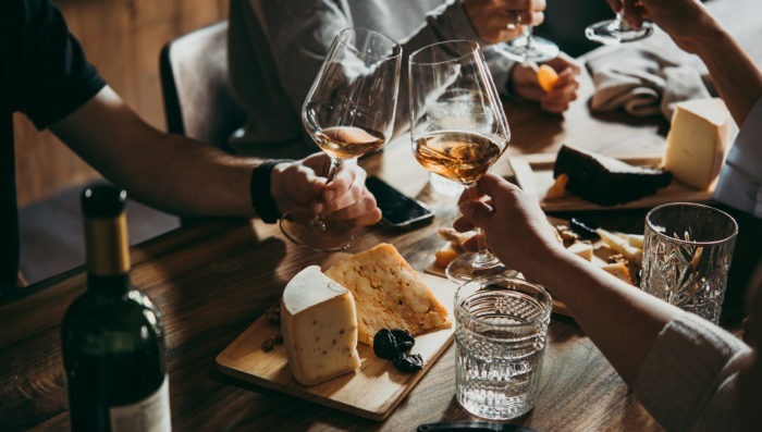 People eating french food, and drinking wine