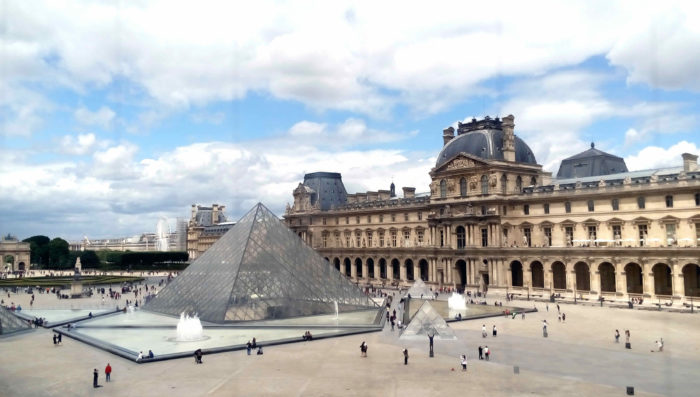 exterior of louvre museum. pyramid entrance in foreground